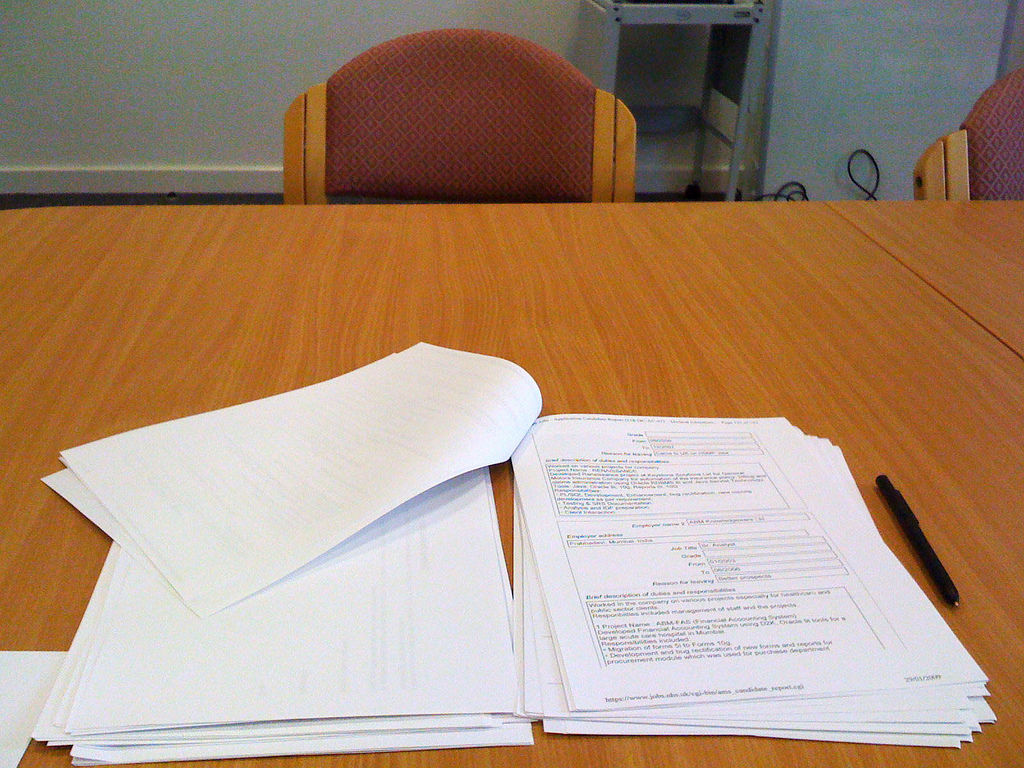 Interview papers and pen on top of a table.