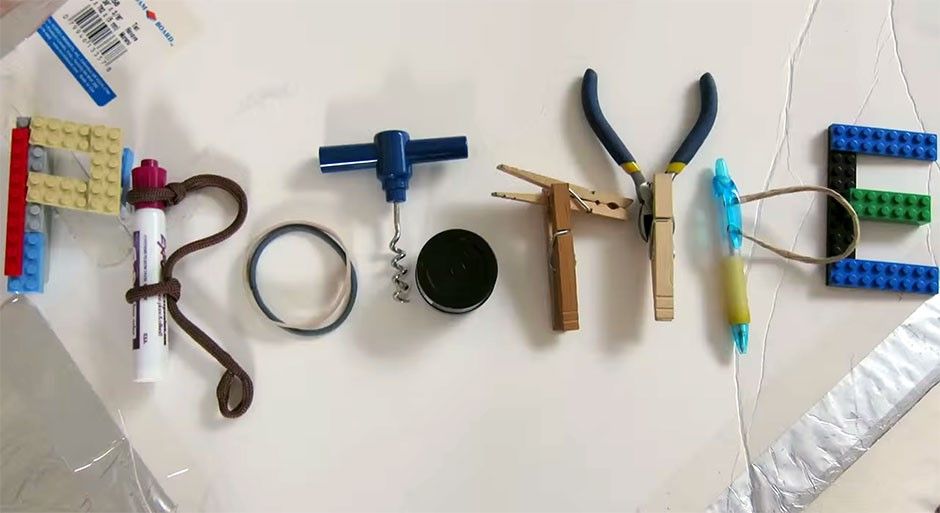 Several tools including pens, cords, lego bricks and elastic bands.