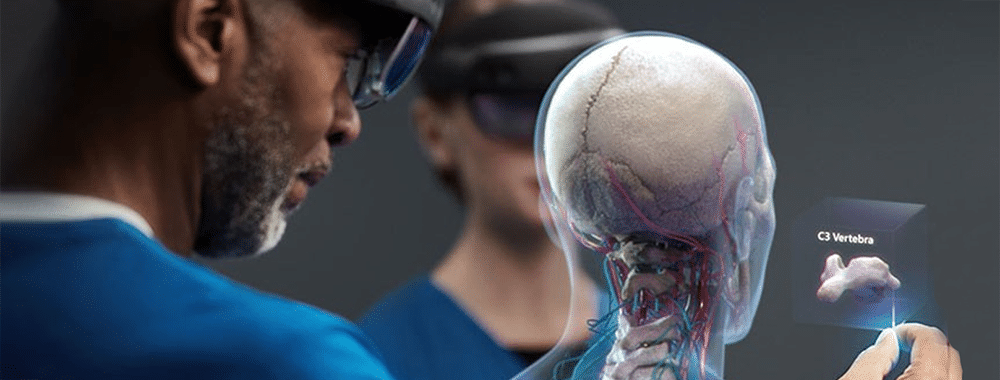 A doctor examining virtual cranium and neck bones with AR.