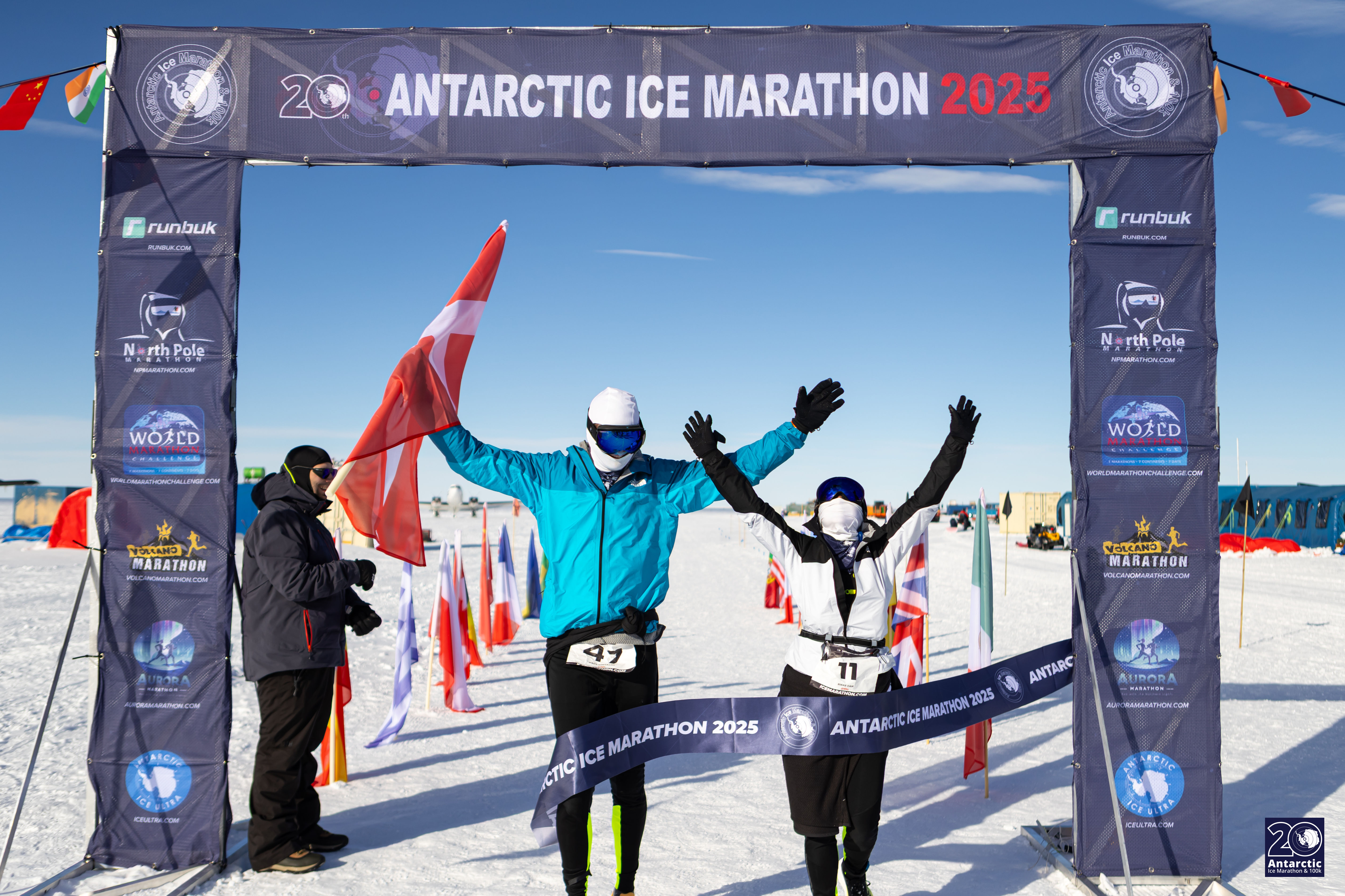 Mads and Rikke crossing the finish line at a marathon in Antarctica