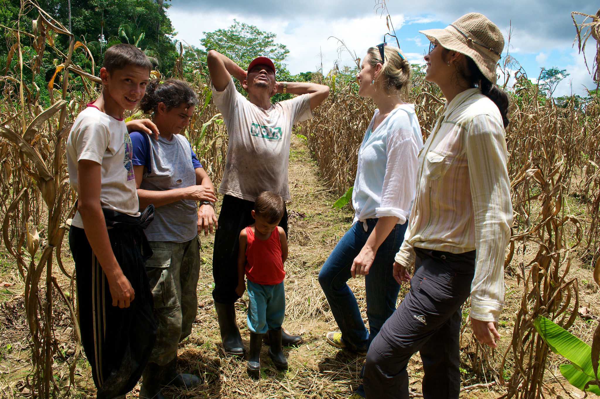 Ethnographer with workers in a field.