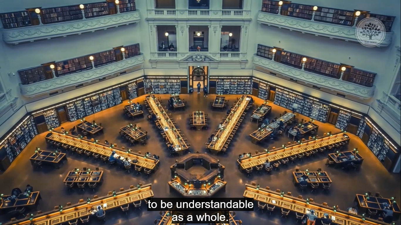 A screenshot showing subtitles over the interior of a large building like a library with 8 long tables leading out from a center, resembling sun rays.