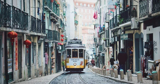 An image showing a Lisbon street scene with a tram car.