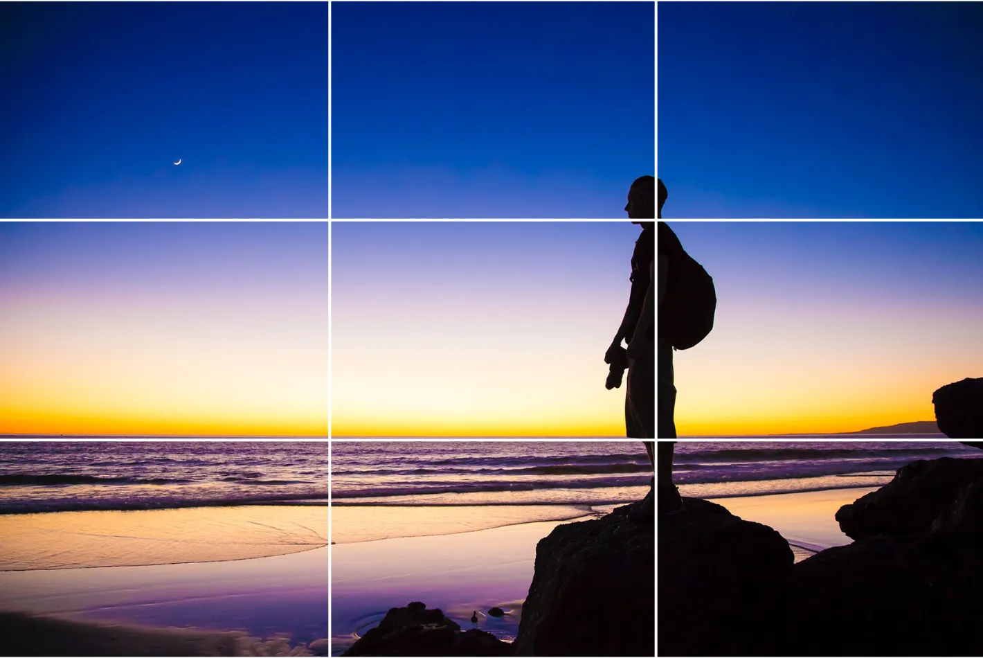 An image of a person looking at a sky within a grid to illustrate the rule of thirds.